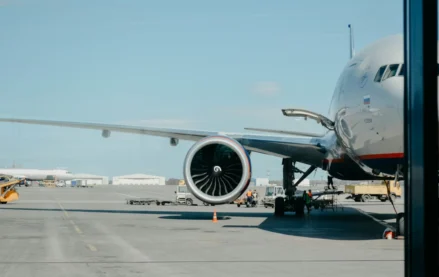 Airplane at gate with ground crew