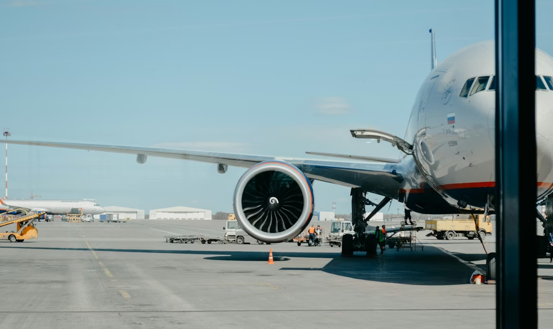Airplane at gate with ground crew