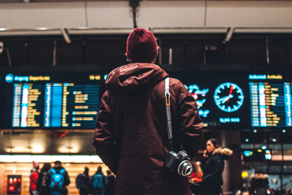 Passenger checking flight information board