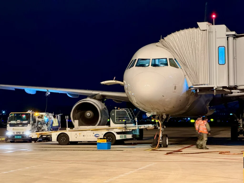 Ground crew and vehicles servicing an aircraft