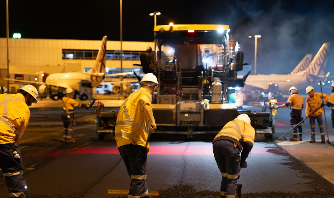 Airport maintenance workers performing runway maintenance